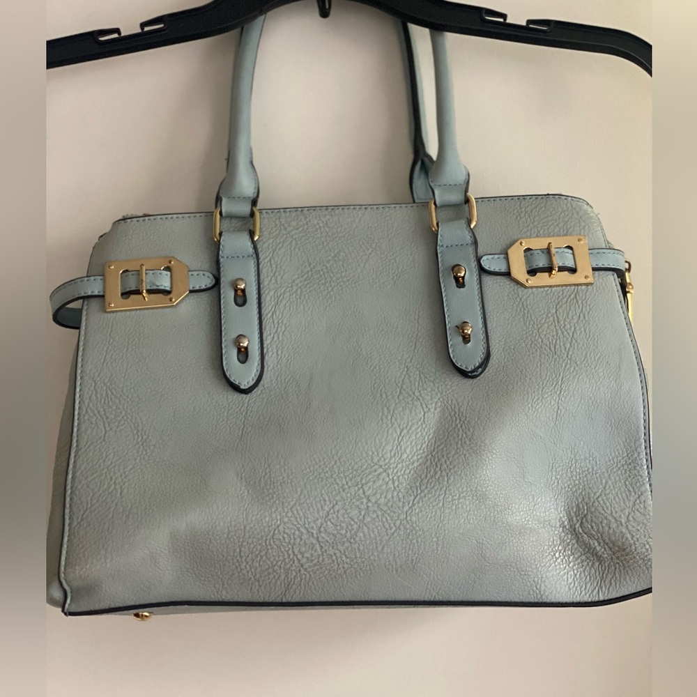 Women’s light blue purse with gold hardware